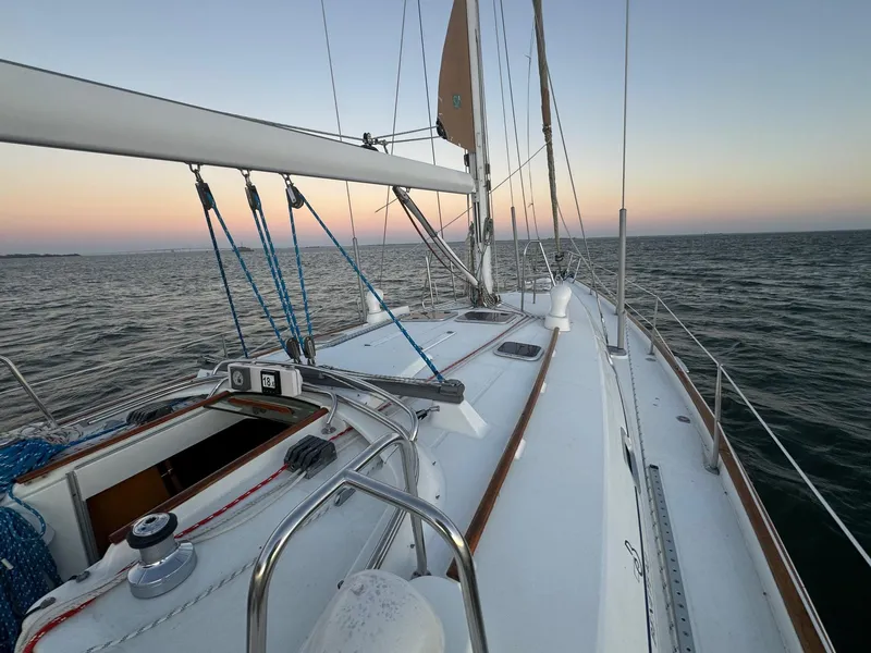 Slide: The Image of Beneteau 50 sailboat on open water at sunset, 2002 model. - 4