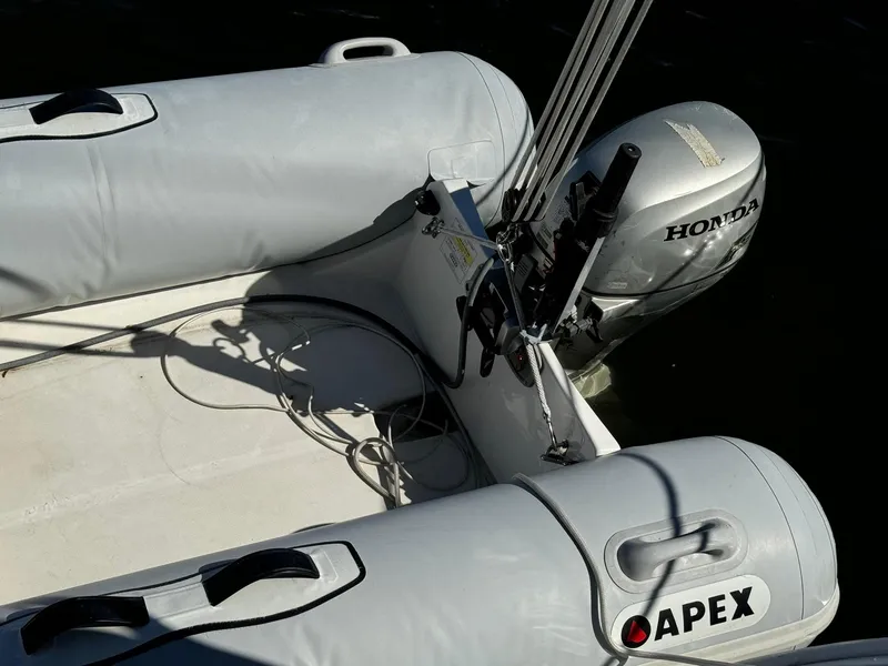 Slide: The Image of Inflatable boat with Honda motor, Apex branding, near Beneteau 50, 2002 model. - 40