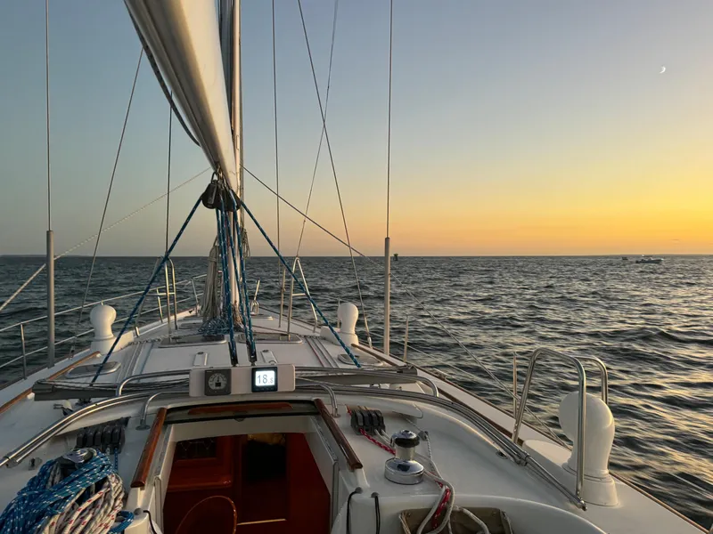 Slide: The Image of Beneteau 50 sailboat at sunset, 2002 model, cruising on open sea. - 43