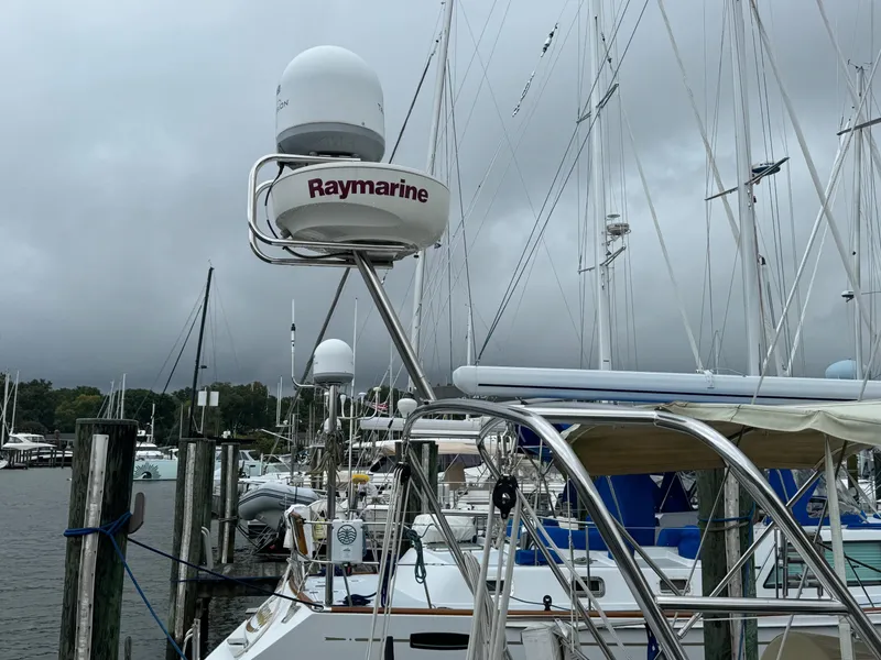 Slide: The Image of Beneteau 50 sailboat with Raymarine radar, docked in a marina under cloudy skies. - 8