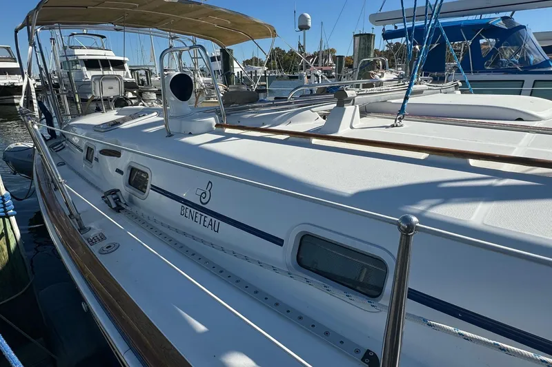 Slide: The Image of 2002 Beneteau 50 sailboat docked at marina, featuring sleek design and spacious deck. - 9