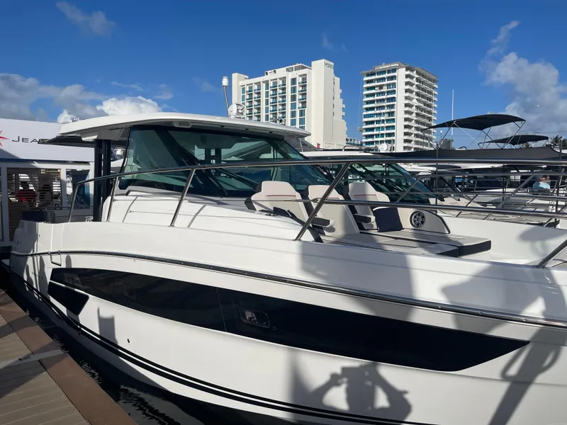 Slide: The Image of 2025 Jeanneau Leader 12.5 WA yacht docked, with modern design and cityscape background. - 1