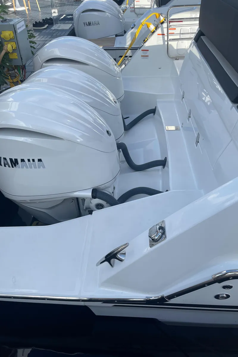 Slide: The Image of 2025 Jeanneau Leader 12.5 WA with Yamaha outboard engines, rear view. - 12