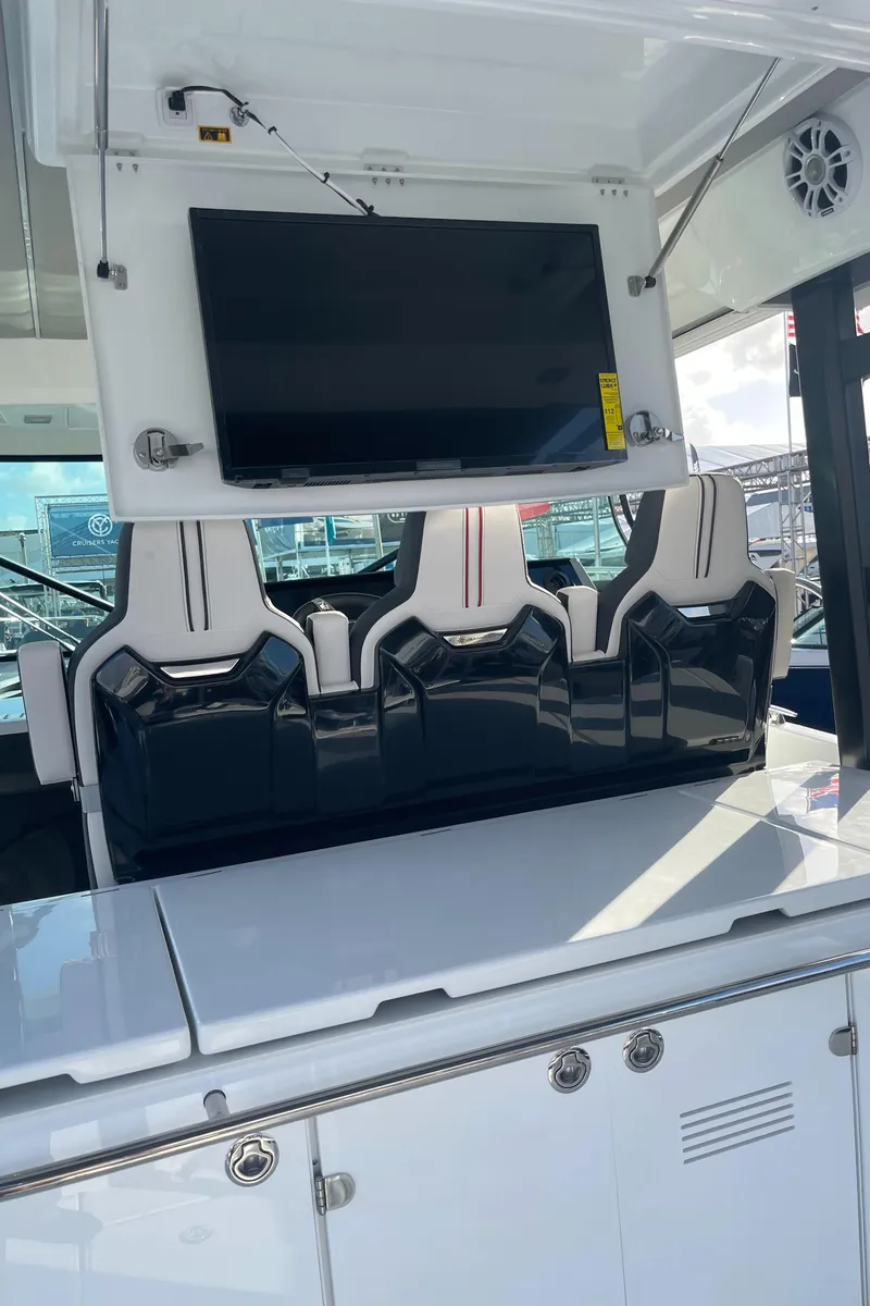 Slide: The Image of 2025 Jeanneau Leader 12.5 WA boat interior with seating and mounted TV. - 14