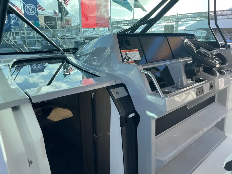 Slide: The Image of 2025 Jeanneau Leader 12.5 WA boat cockpit with modern controls and sleek design. - 7