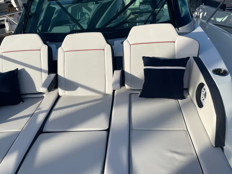 Slide: The Image of Jeanneau Leader 12.5 WA 2025 boat with cushioned seating and pillows. - 11