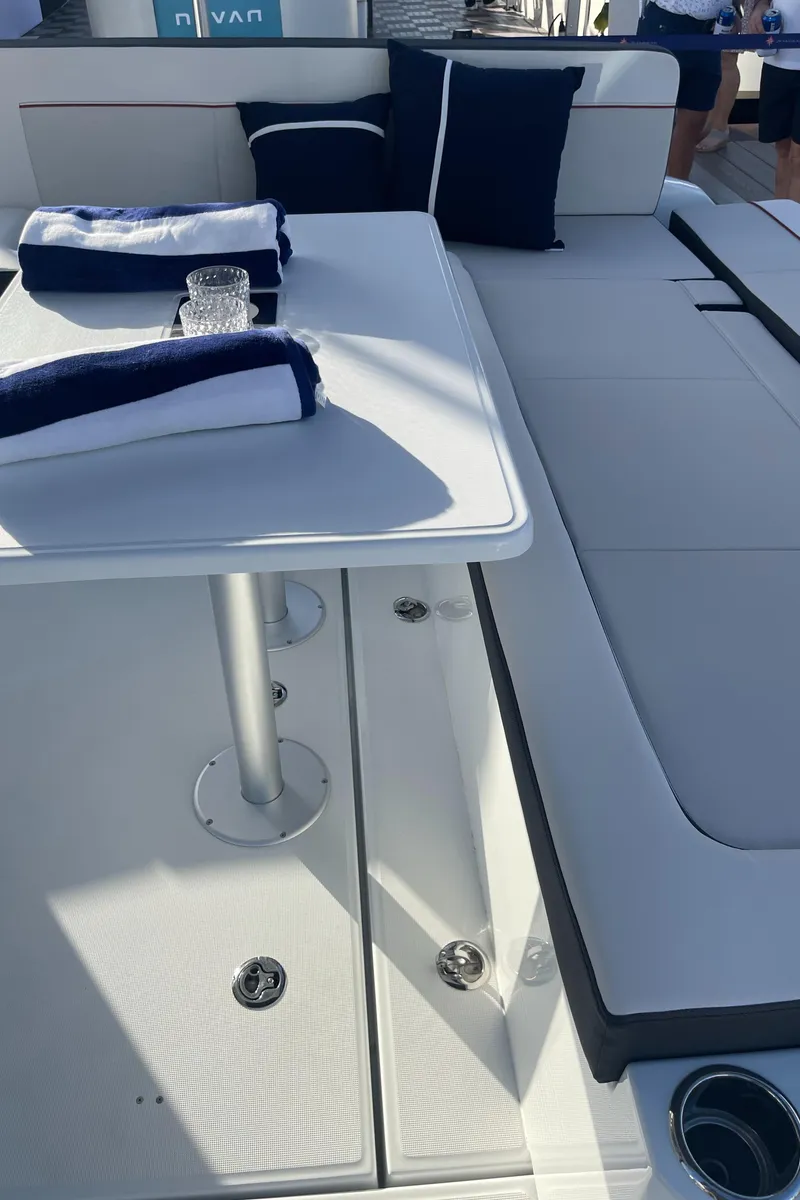 Slide: The Image of 2025 Jeanneau Leader 12.5 WA boat interior with table and seating area. - 13