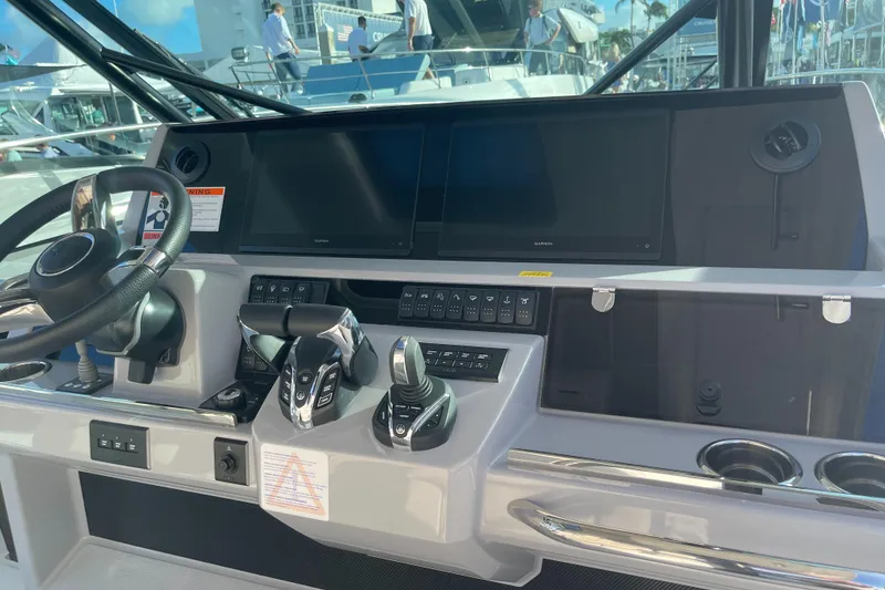 Slide: The Image of 2025 Jeanneau Leader 12.5 WA helm with modern controls and dual screens. - 15