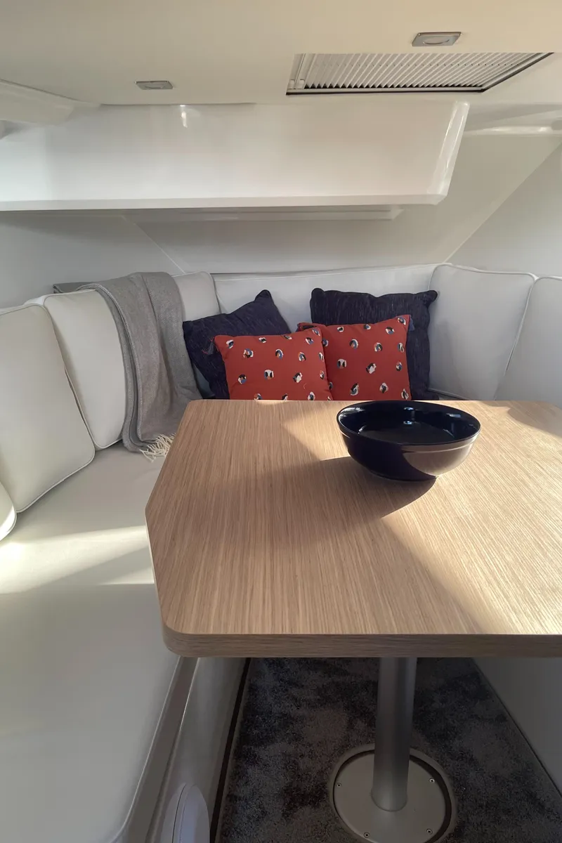 Slide: The Image of Cozy interior of 2025 Jeanneau Leader 12.5 WA with cushions and table. - 17