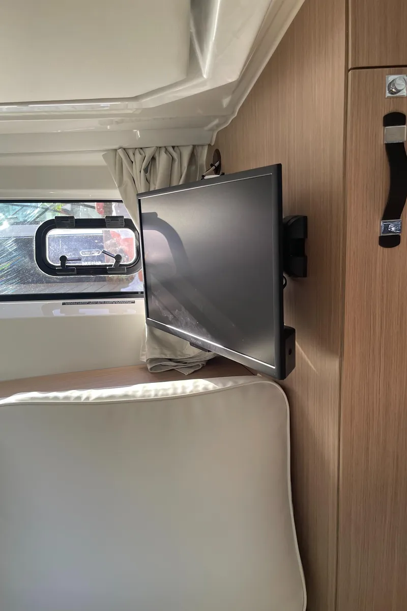 Slide: The Image of Interior of 2025 Jeanneau Leader 12.5 WA with TV and window view. - 22