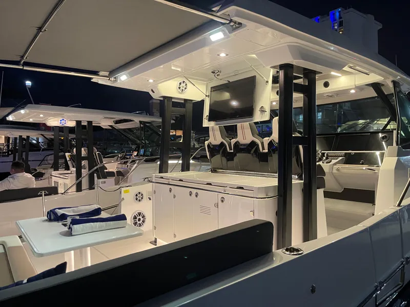 Slide: The Image of 2025 Jeanneau Leader 12.5 WA luxury yacht interior at night, featuring modern amenities. - 26