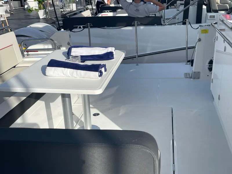 Slide: The Image of 2025 Jeanneau Leader 12.5 WA boat deck with table and towels. - 3