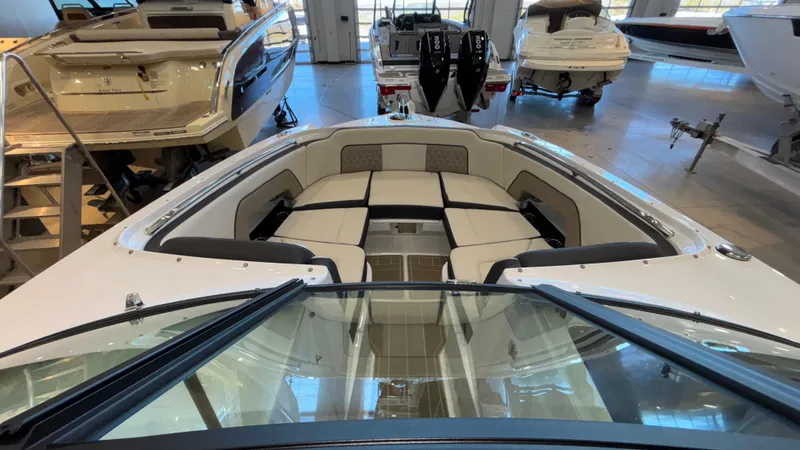 Slide: The Image of 2025 Monterey M65 boat interior with spacious seating in showroom. - 11