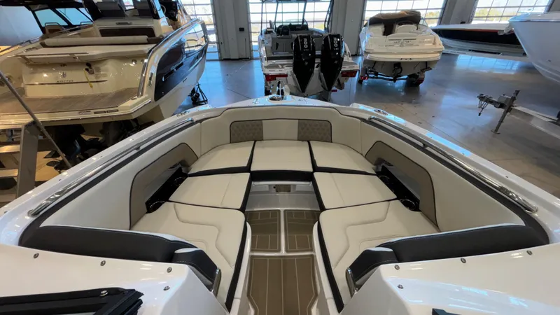 Slide: The Image of 2025 Monterey M65 boat interior with spacious seating in a showroom. - 12