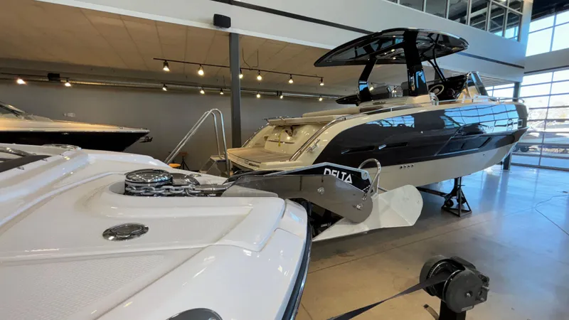 Slide: The Image of 2025 Monterey M65 boat displayed in a modern showroom. - 16