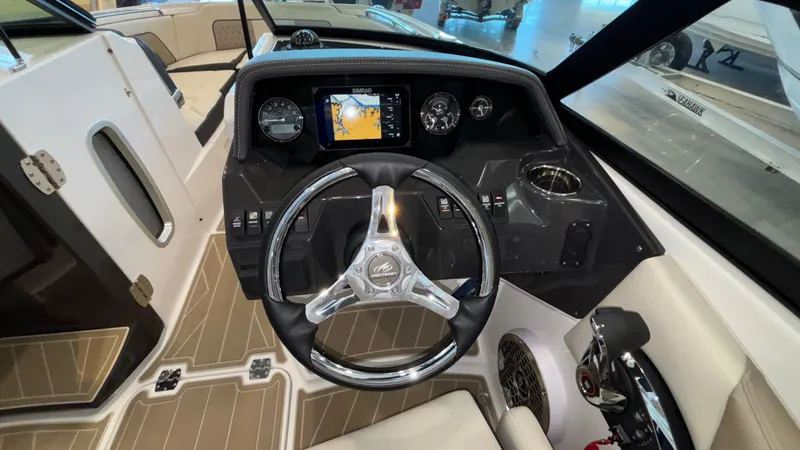 Slide: The Image of 2025 Monterey M65 boat dashboard with steering wheel and navigation display. - 18