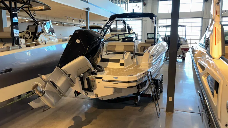 Slide: The Image of 2025 Monterey M65 boat in showroom, rear view with outboard motor. - 2