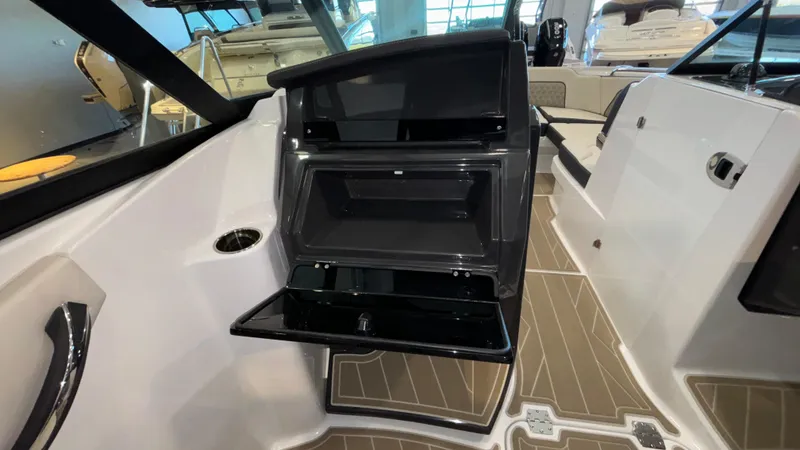 Slide: The Image of 2025 Monterey M65 boat interior with open storage compartment and sleek design. - 21