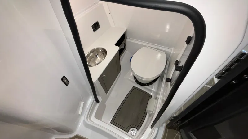 Slide: The Image of Compact bathroom in 2025 Monterey M65 boat with toilet and sink. - 23