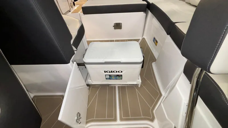 Slide: The Image of Monterey M65 2025 boat interior with Igloo cooler and seating area. - 29
