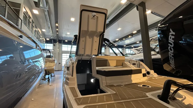 Slide: The Image of 2025 Monterey M65 boat in showroom, open storage compartment, modern design. - 34
