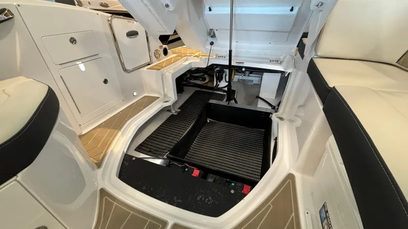 Slide: The Image of Interior view of 2025 Monterey M65 boat engine compartment, showcasing storage and seating areas. - 38