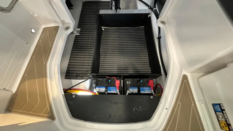 Slide: The Image of Monterey M65 2025 boat battery compartment with dual batteries and wiring. - 39