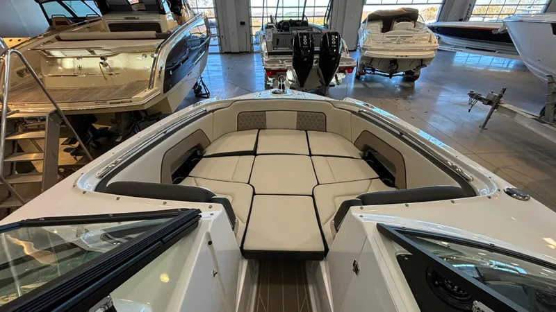 Slide: The Image of 2025 Monterey M65 boat interior with spacious seating in a showroom. - 43