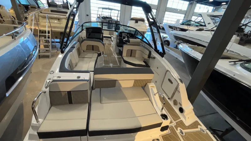 Slide: The Image of 2025 Monterey M65 boat interior with spacious seating and modern design in showroom. - 6