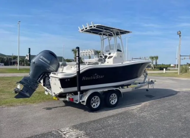 Slide: The Image of 2022 NauticStar 2102 Legacy boat on trailer with Yamaha outboard motor. - 0