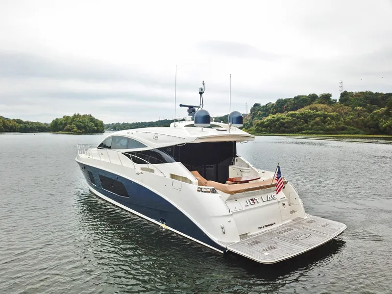 Slide: The Image of 2016 Sea Ray L650 yacht on a serene lake with lush greenery. - 12