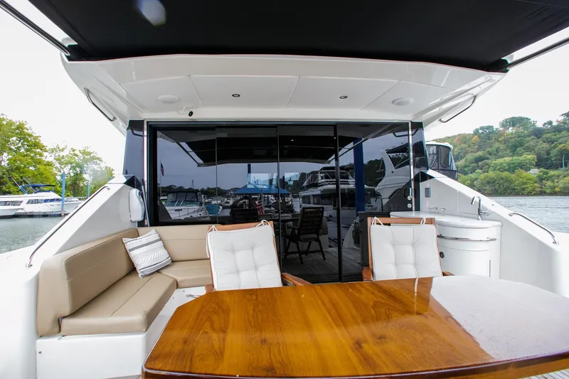 Slide: The Image of Luxurious 2016 Sea Ray L650 yacht with elegant outdoor seating and dining area. - 21