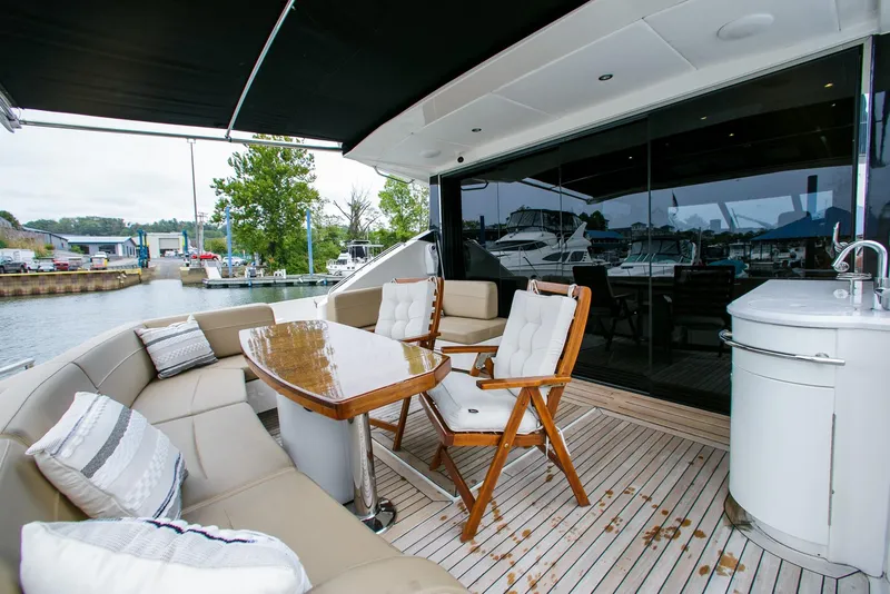 Slide: The Image of Luxurious 2016 Sea Ray L650 yacht deck with seating and table, docked at marina. - 22