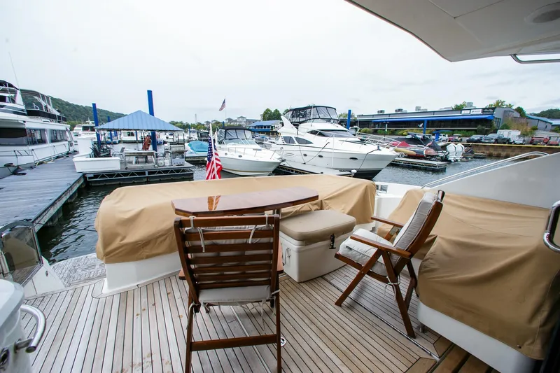 Slide: The Image of 2016 Sea Ray L650 yacht deck with chairs and table at marina. - 25