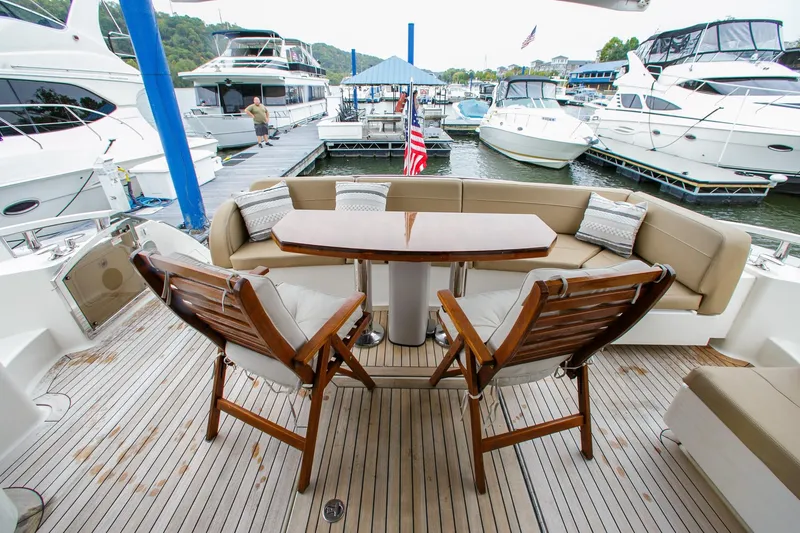 Slide: The Image of Luxurious 2016 Sea Ray L650 yacht deck with seating and table at marina. - 26