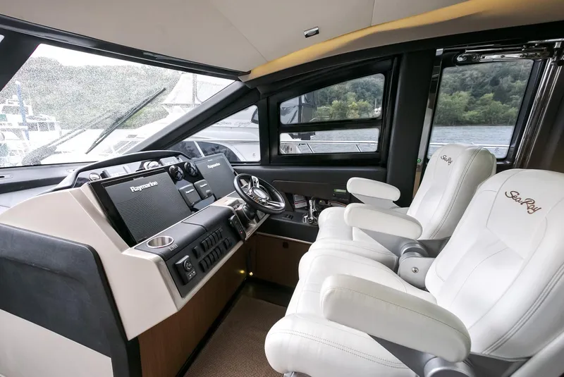 Slide: The Image of Luxurious 2016 Sea Ray L650 yacht cockpit with modern controls and plush seating. - 27