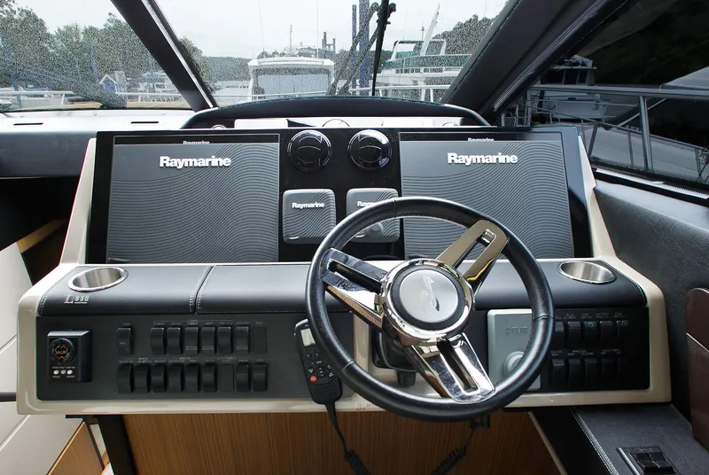 Slide: The Image of Cockpit of 2016 Sea Ray L650 yacht with Raymarine navigation system and steering wheel. - 28