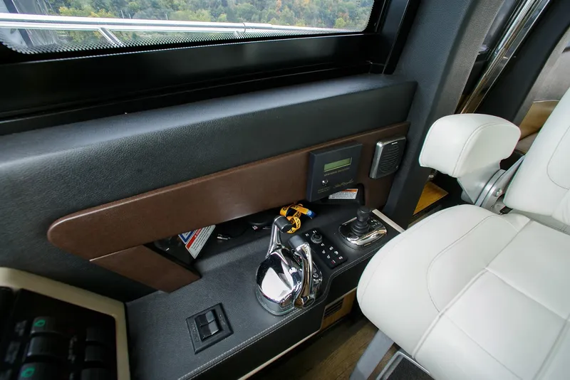 Slide: The Image of Interior helm controls of 2016 Sea Ray L650 yacht with leather seating. - 30