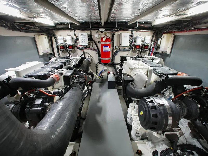 Slide: The Image of Engine room of 2016 Sea Ray L650 yacht, featuring dual engines and fire safety equipment. - 33