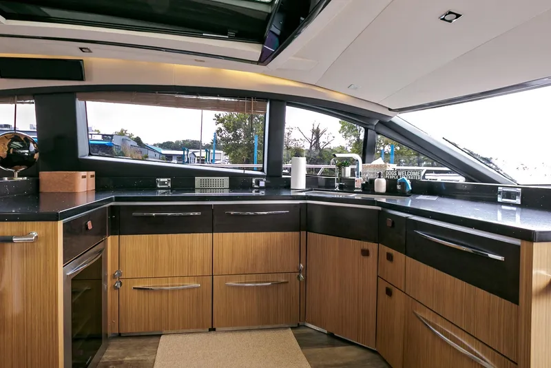 Slide: The Image of Luxurious 2016 Sea Ray L650 yacht kitchen with modern wood cabinetry and sleek countertops. - 35