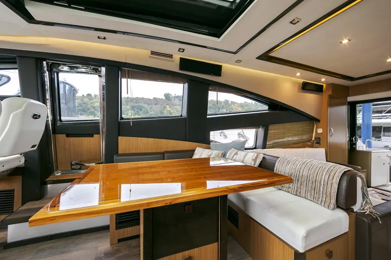 Slide: The Image of Luxurious interior of 2016 Sea Ray L650 yacht with modern seating and wooden table. - 36