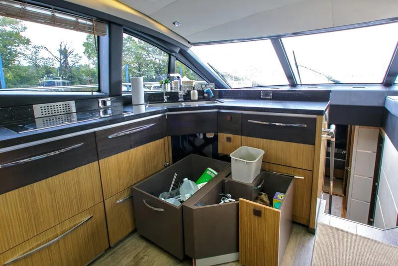 Slide: The Image of Luxurious 2016 Sea Ray L650 yacht kitchen with modern cabinetry and large windows. - 39