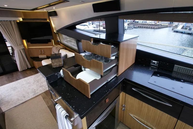 Slide: The Image of Luxurious 2016 Sea Ray L650 yacht interior with modern kitchen and marina view. - 40