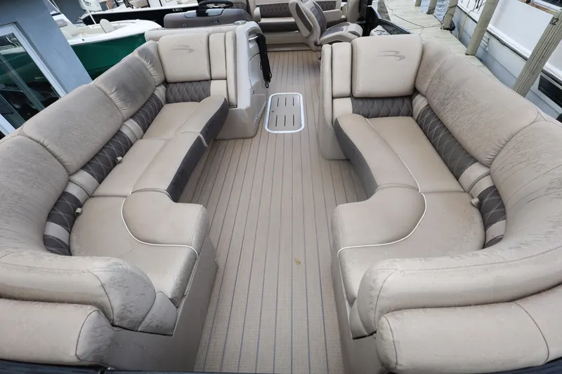 Slide: The Image of 2019 Bennington R 23 RSBA pontoon boat interior with beige seating and spacious layout. - 10