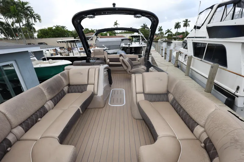 Slide: The Image of 2019 Bennington R 23 RSBA pontoon boat with spacious seating at a marina. - 11