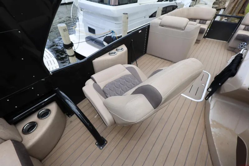 Slide: The Image of 2019 Bennington R 23 RSBA boat interior with beige seating and wood flooring. - 14