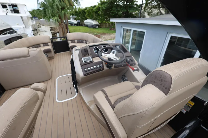 Slide: The Image of 2019 Bennington R 23 RSBA boat interior with beige seating and modern dashboard. - 15