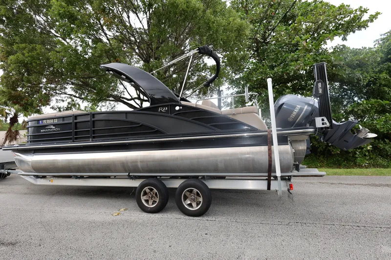 Slide: The Image of 2019 Bennington R 23 RSBA pontoon boat on trailer, parked on roadside. - 2