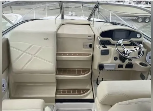 Slide: The Image of 2020 Regal 26 XO boat interior with beige seating and modern dashboard. - 11