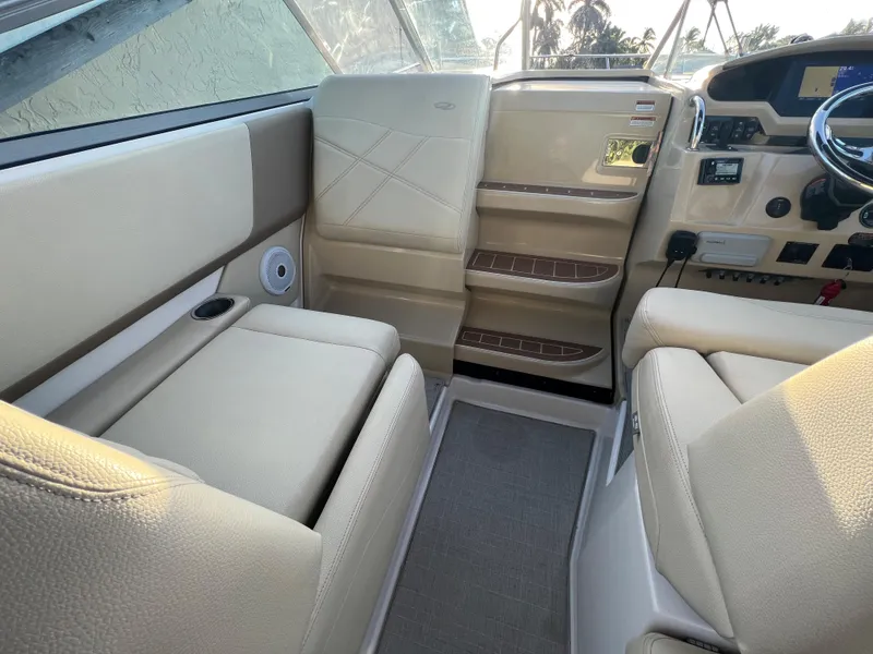 Slide: The Image of 2020 Regal 26 XO boat interior with beige seating and modern dashboard. - 15